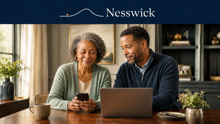Older mother and adult son reviewing phone security settings together